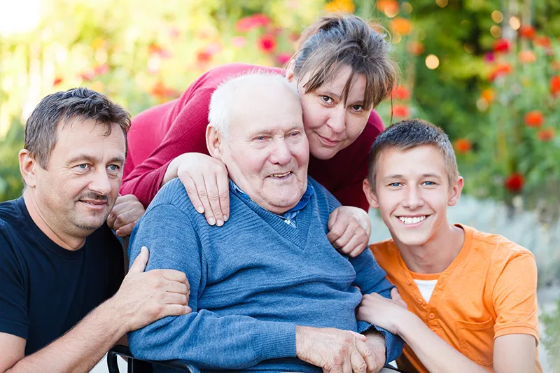 Family with older man in chair Support for families and whānau from Franklin Hospice
